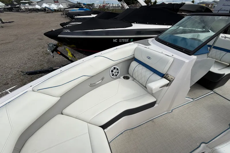 Slide: The Image of 2021 Regal LS2 Surf boat interior with white seating and blue accents. - 11