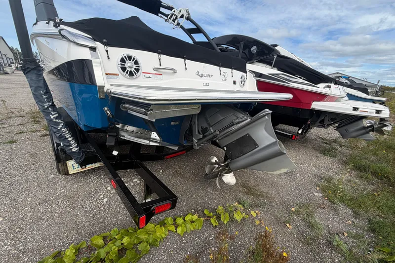 Slide: The Image of 2021 Regal LS2 Surf boat on trailer, showcasing rear view and propeller. - 1