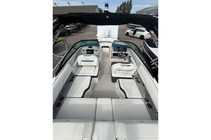 Slide: The Image of 2021 Regal LS2 Surf boat interior with luxurious white seating and modern dashboard. - 4