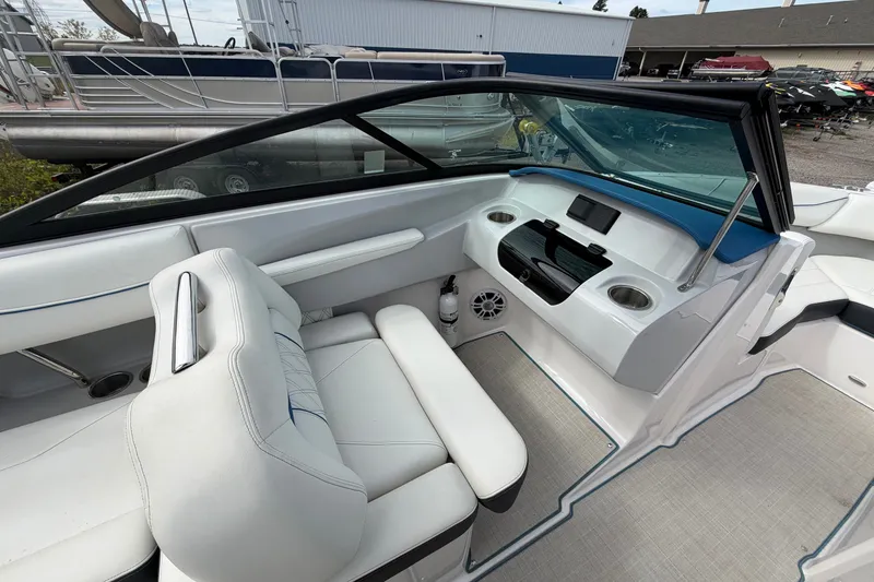 Slide: The Image of 2021 Regal LS2 Surf boat interior with white seating and modern dashboard. - 8
