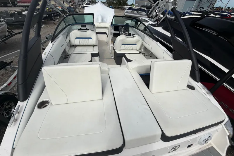 Slide: The Image of 2021 Regal LS2 Surf boat interior with white seating and sleek design. - 3