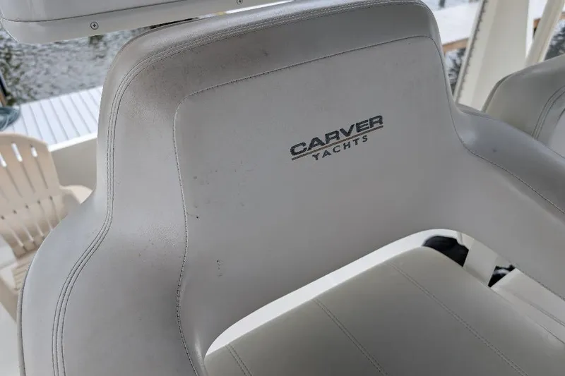 Slide: The Image of Carver 356 Motor Yacht 2003 captain's chair with logo, white upholstery. - 16