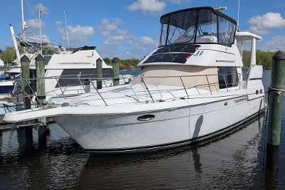 Slide: The Image of 2003 Carver 356 Motor Yacht docked in a marina under a clear blue sky. - 1