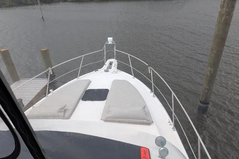 Slide: The Image of Bow view of 2003 Carver 356 Motor Yacht docked by wooden posts. - 10
