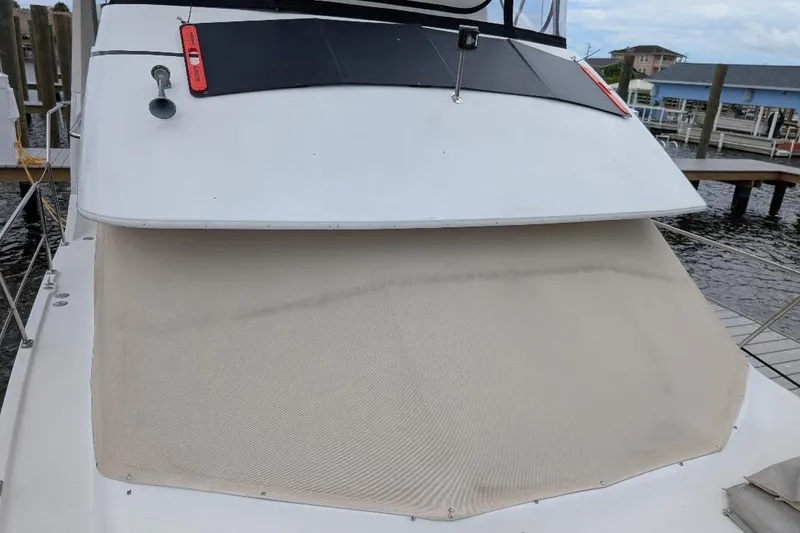 Slide: The Image of 2003 Carver 356 Motor Yacht with covered deck, docked at marina. - 7