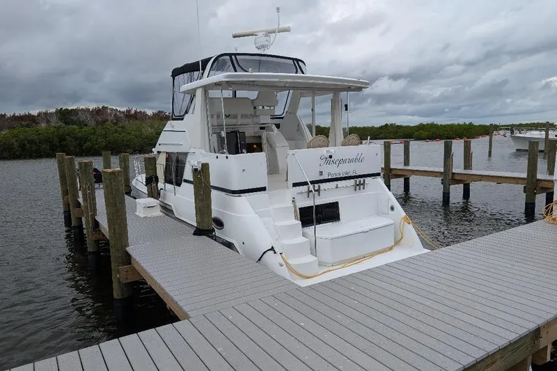 Slide: The Image of 2003 Carver 356 Motor Yacht docked at marina under cloudy skies. - 6