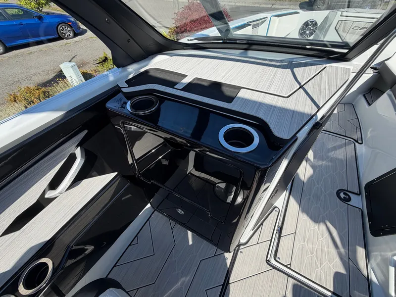 Slide: The Image of The image shows the cockpit of a 2023 Yamaha 222XE boat with modern fittings and cup holders. - 14