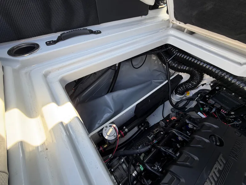 Slide: The Image of An open engine compartment of a 2023 Yamaha 222XE boat with visible engine and wiring. - 29