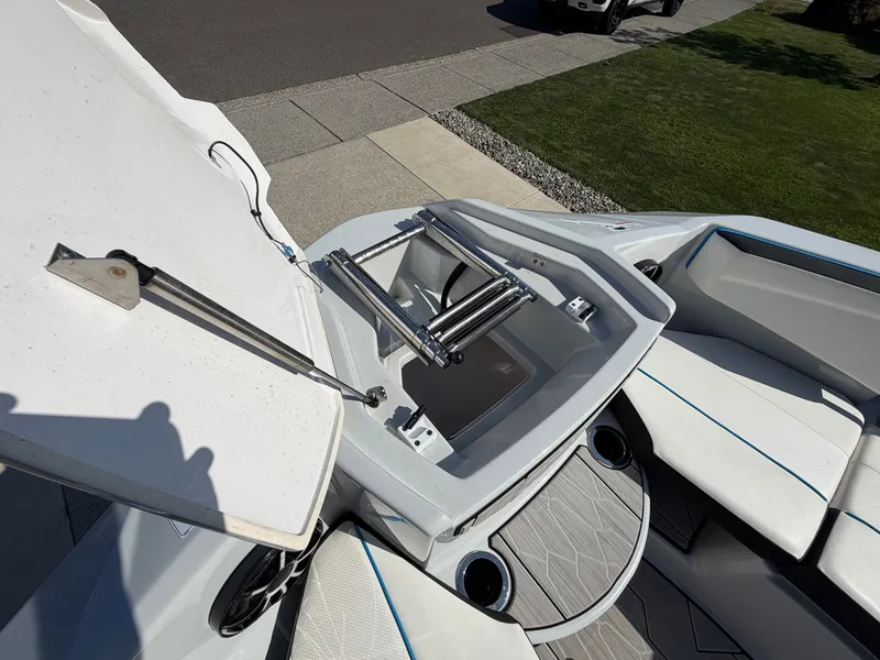 Slide: The Image of The image shows the bow area of a 2023 Yamaha 222XE boat with storage and seating. - 21