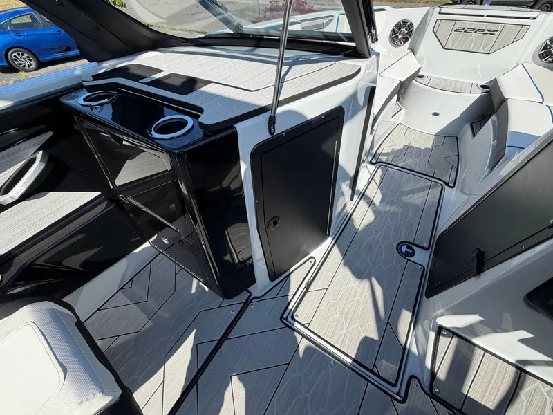 Slide: The Image of The image shows the interior of a 2023 Yamaha 222XE boat with modern seating and sleek surfaces. - 15