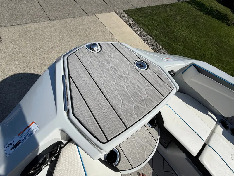 Slide: The Image of The image shows the deck of a 2023 Yamaha 222XE boat with gray upholstery and modern details. - 22