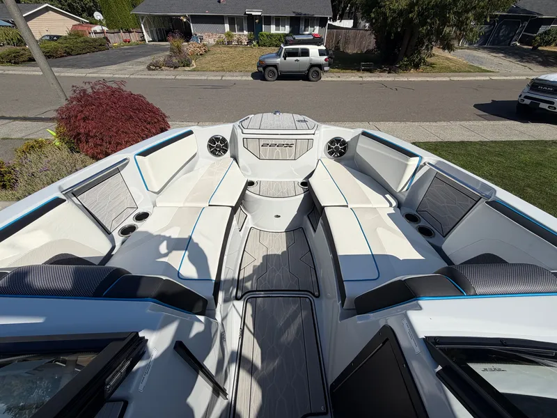 Slide: The Image of The image shows the spacious bow area of a 2023 Yamaha 222XE boat in a residential area. - 18
