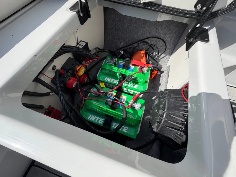 Slide: The Image of The image shows the battery compartment of a Yamaha 222XE boat with two green batteries. - 30