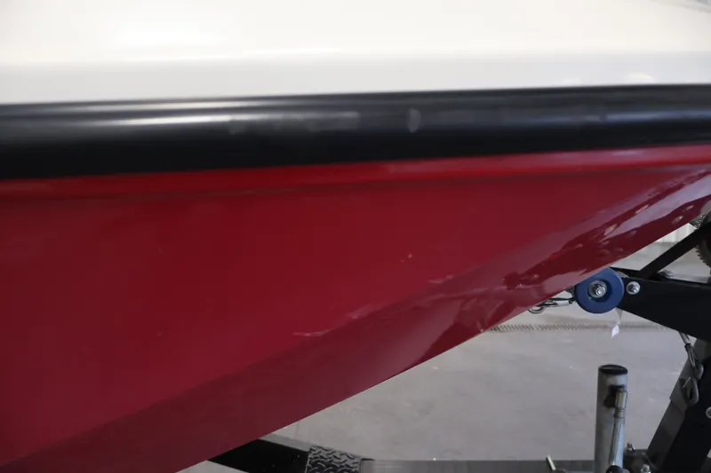 Slide: The Image of Red hull of 2015 Bayliner Element 180 XL boat on trailer. - 48