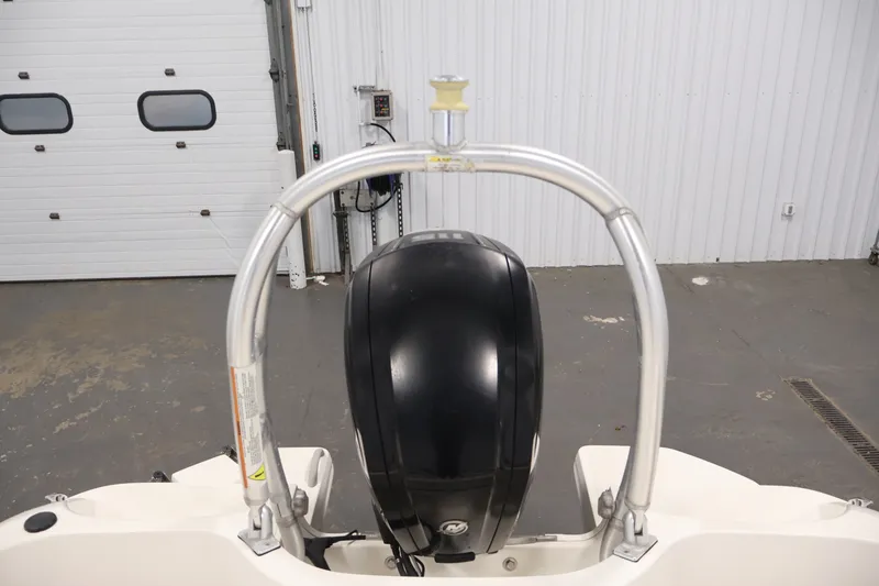 Slide: The Image of 2015 Bayliner Element 180 XL boat engine and arch in a garage setting. - 39