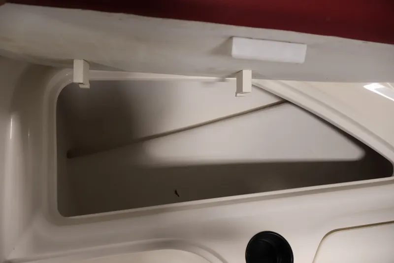 Slide: The Image of Storage compartment of a 2015 Bayliner Element 180 XL boat, featuring a sleek interior design. - 18