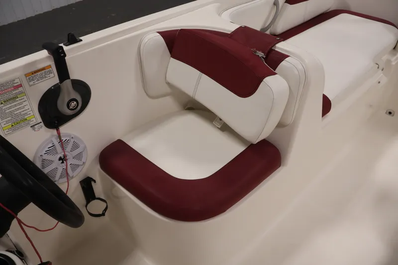 Slide: The Image of 2015 Bayliner Element 180 XL boat interior with maroon and white seating. - 30