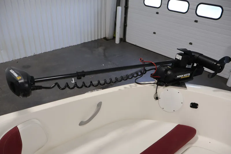 Slide: The Image of 2015 Bayliner Element 180 XL with Minn Kota trolling motor in a garage setting. - 11