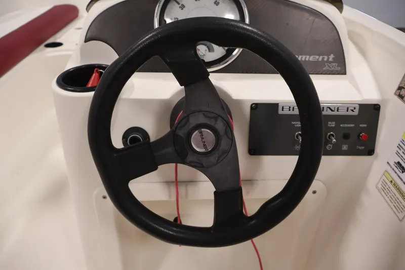 Slide: The Image of 2015 Bayliner Element 180 XL boat dashboard with steering wheel and control panel. - 23