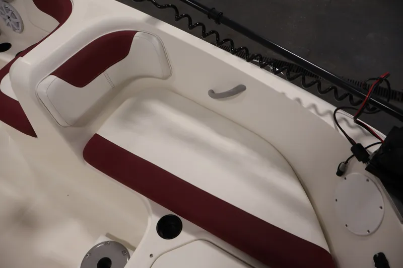 Slide: The Image of Interior seating of a 2015 Bayliner Element 180 XL boat with red and white upholstery. - 17