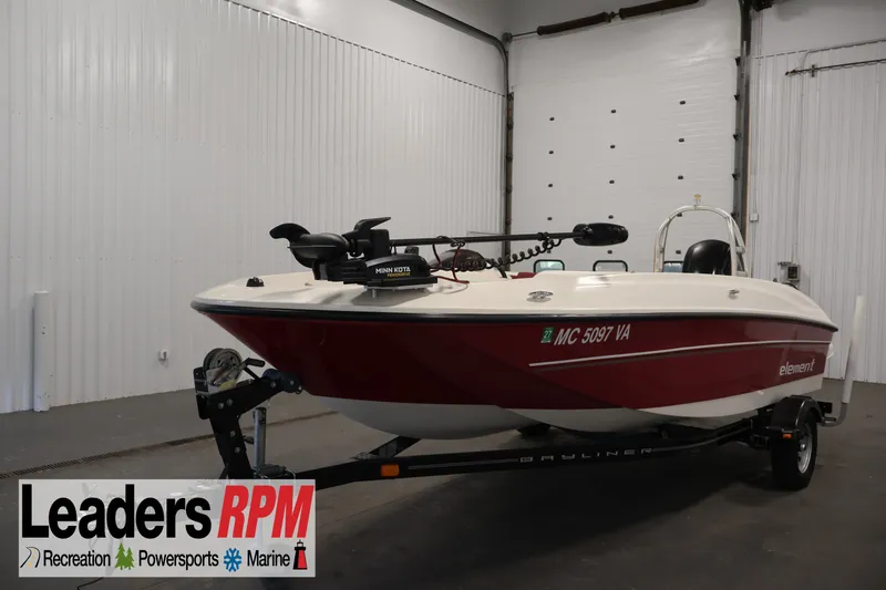 The Image of 2015 Bayliner Element 180 XL boat in a showroom, featuring a red and white design. - 1