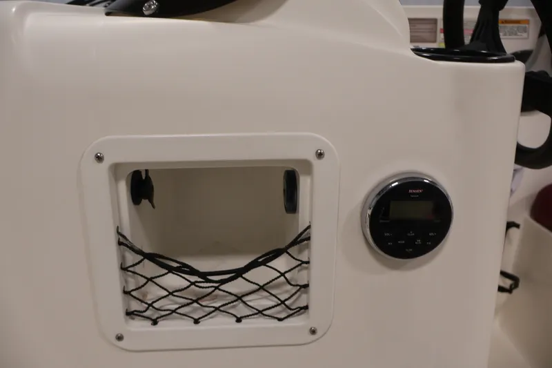Slide: The Image of 2015 Bayliner Element 180 XL boat dashboard with storage compartment and Jensen audio system. - 26
