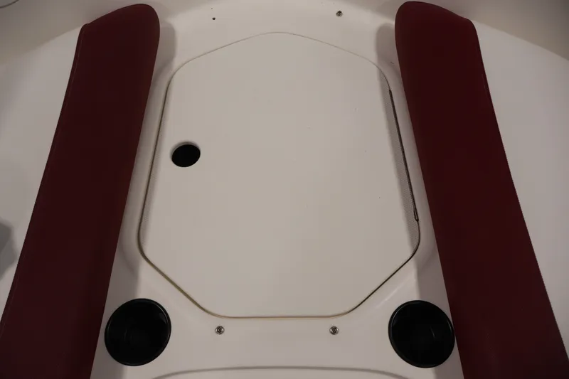 Slide: The Image of 2015 Bayliner Element 180 XL boat interior with red cushions and storage compartment. - 15