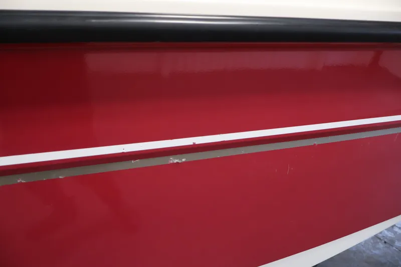 Slide: The Image of Red hull of 2015 Bayliner Element 180 XL boat with white stripe detail. - 49