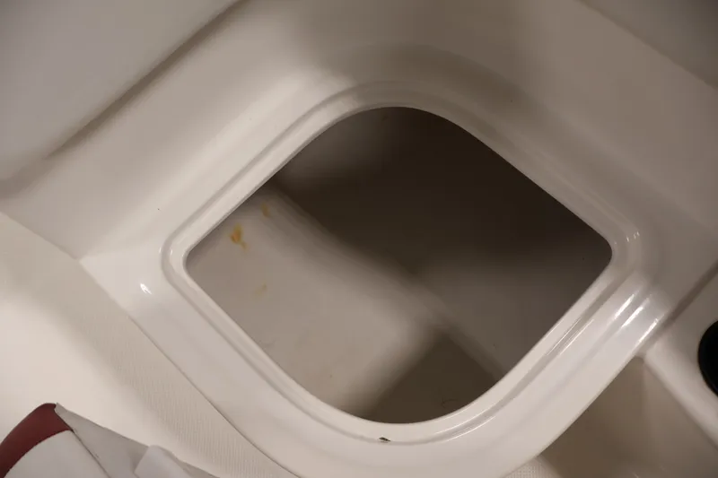 Slide: The Image of Storage compartment in 2015 Bayliner Element 180 XL boat, featuring clean white interior. - 35