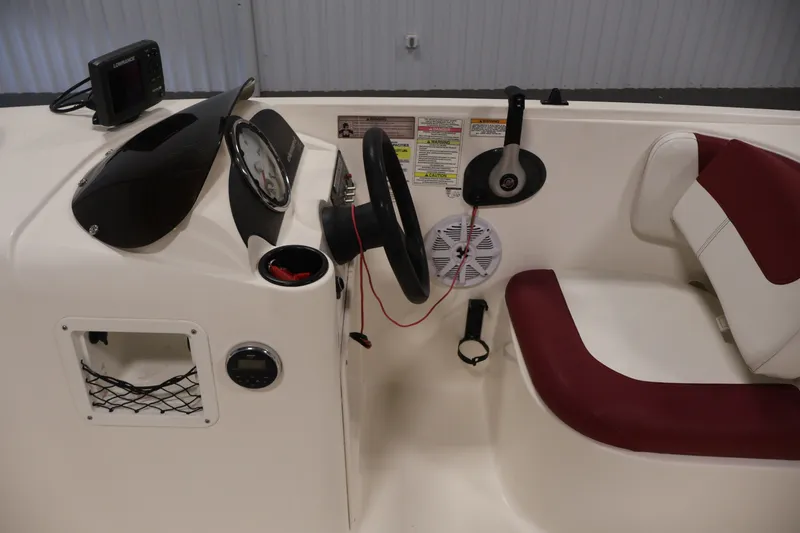 Slide: The Image of 2015 Bayliner Element 180 XL boat dashboard with steering wheel and controls. - 21