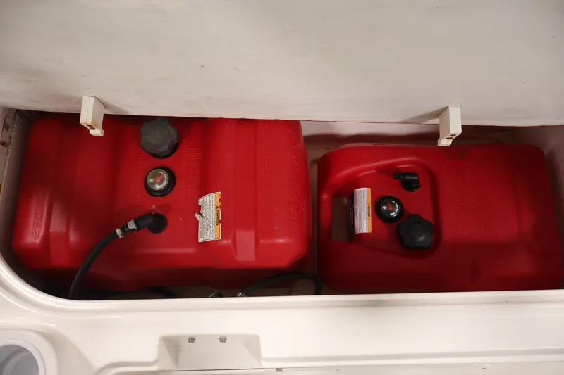 Slide: The Image of Red fuel tanks in a 2015 Bayliner Element 180 XL boat compartment. - 37
