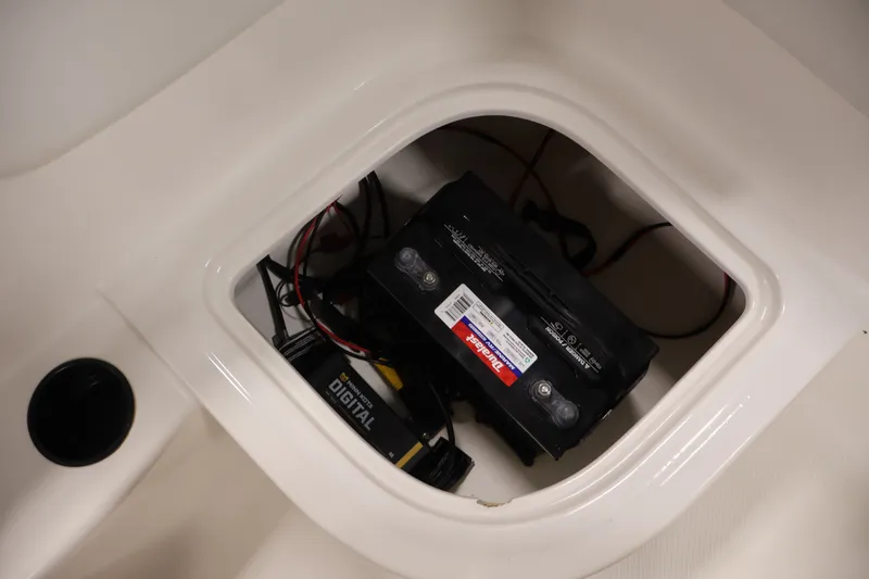 Slide: The Image of Battery compartment of 2015 Bayliner Element 180 XL boat with wiring and digital charger. - 33