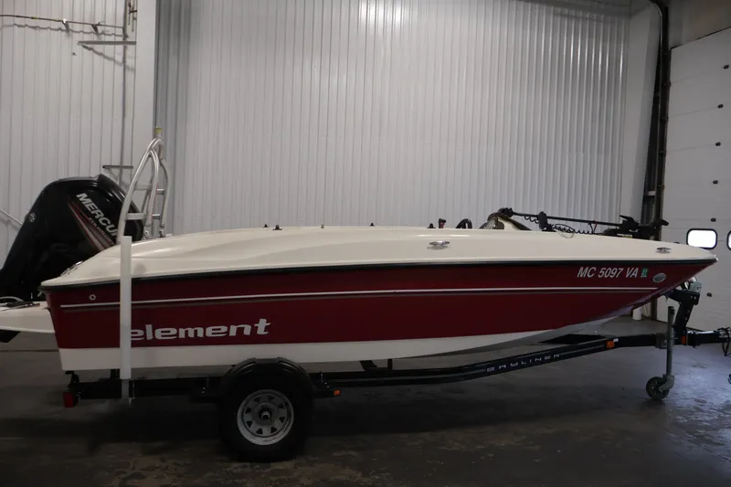 Slide: The Image of 2015 Bayliner Element 180 XL boat in a garage, red and white exterior. - 4