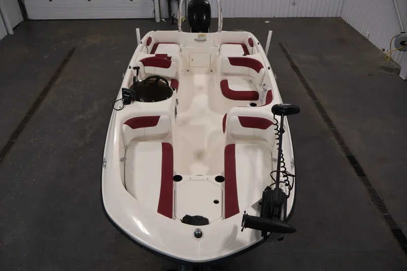 Slide: The Image of 2015 Bayliner Element 180 XL boat with red and white seating in a garage. - 9