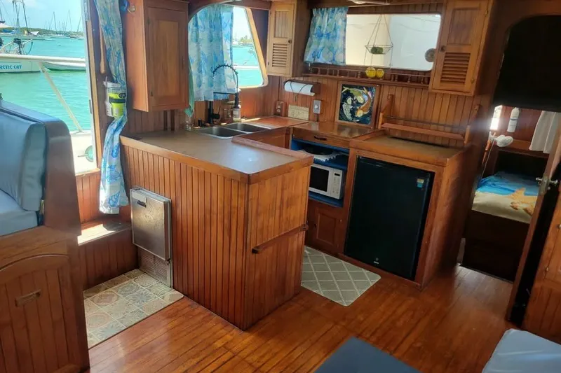 Slide: The Image of Interior of 1980 DeFever 41 Trawler with wooden cabinetry and nautical decor. - 6