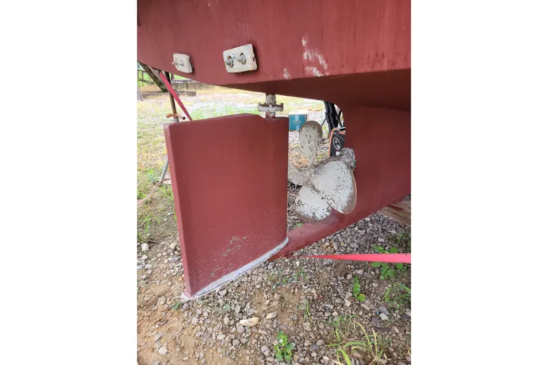 Slide: The Image of 1980 DeFever 41 Trawler propeller and rudder detail on dry land. - 11