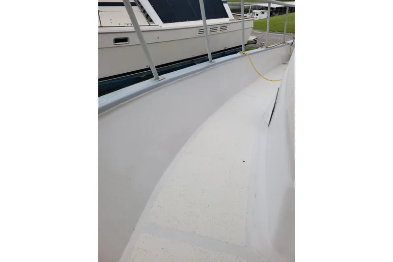 Slide: The Image of 1980 DeFever 41 Trawler deck view with railing and docked boat. - 17
