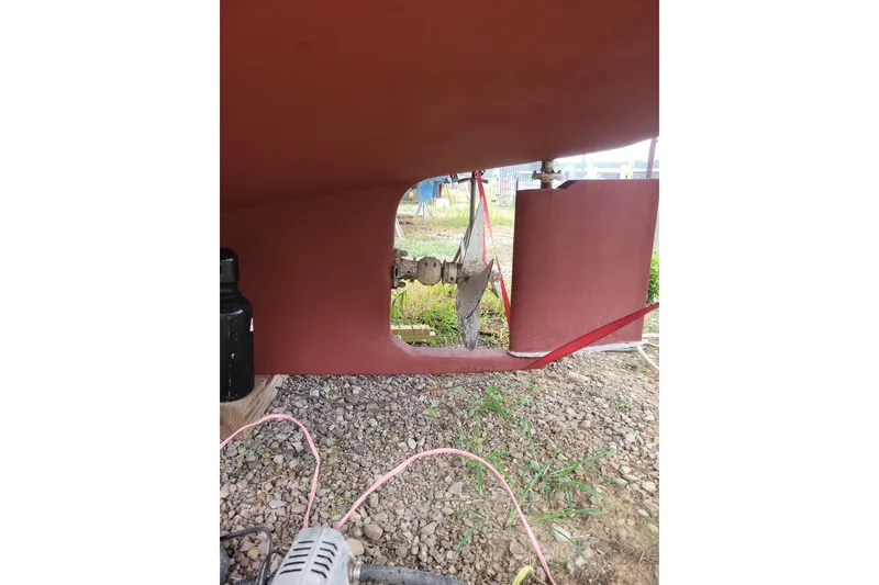 Slide: The Image of 1980 DeFever 41 Trawler hull and propeller detail on gravel surface. - 12