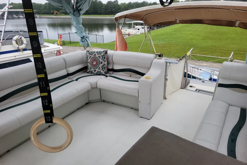 Slide: The Image of 1980 DeFever 41 Trawler with spacious seating area and scenic waterfront view. - 13