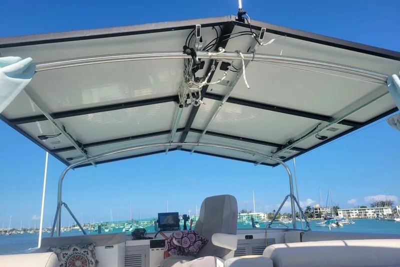 Slide: The Image of 1980 DeFever 41 Trawler helm with canopy, overlooking marina and blue sky. - 3
