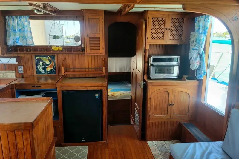 Slide: The Image of Interior of 1980 DeFever 41 Trawler with wood paneling and nautical decor. - 4