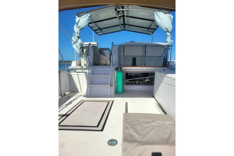 Slide: The Image of 1980 DeFever 41 Trawler deck with stairs, canopy, and ocean view. - 1