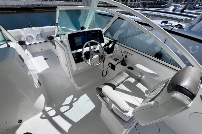 Slide: The Image of 2021 World Cat 230 DC boat interior with modern helm and seating. - 12