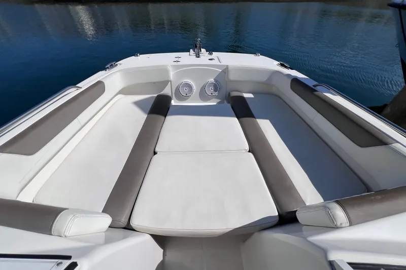 Slide: The Image of 2021 World Cat 230 DC boat interior with cushioned seating and water view. - 18