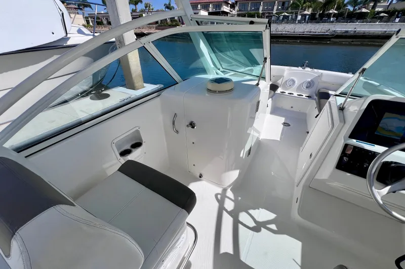 Slide: The Image of Interior view of 2021 World Cat 230 DC boat, featuring seating and control panel. - 13