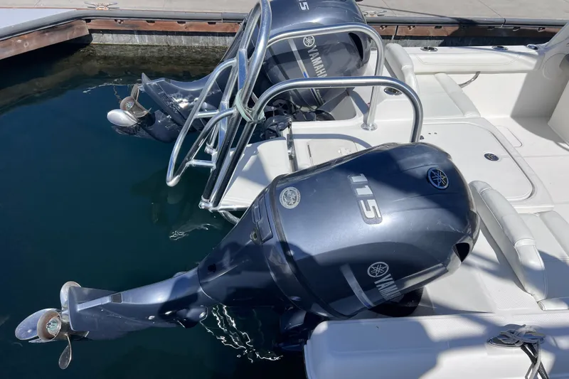 Slide: The Image of 2021 World Cat 230 DC boat with dual Yamaha 115 outboard engines at dock. - 21