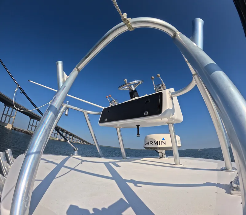 Slide: The Image of The image shows the helm of a Foster 26 boat with a Garmin device, near a bridge. - 7