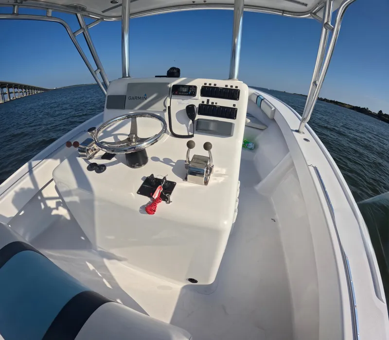 Slide: The Image of The image shows the cockpit of a 2018 Foster 26 boat on the water. - 4