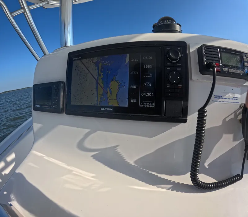 Slide: The Image of The cockpit of a Foster 26 boat with a Garmin navigation system and radio. - 15
