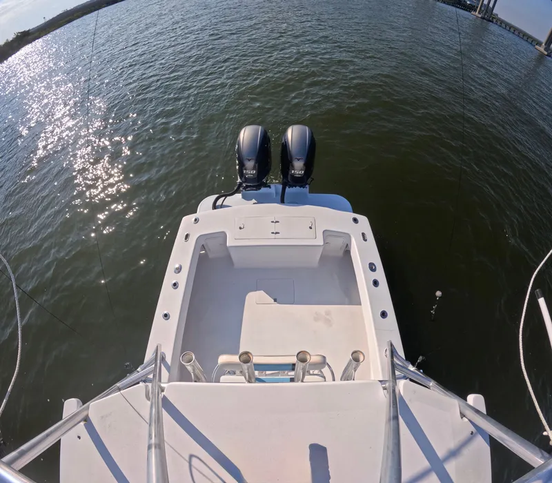 Slide: The Image of The image shows the stern of a boat with two outboard motors on calm water. - 10